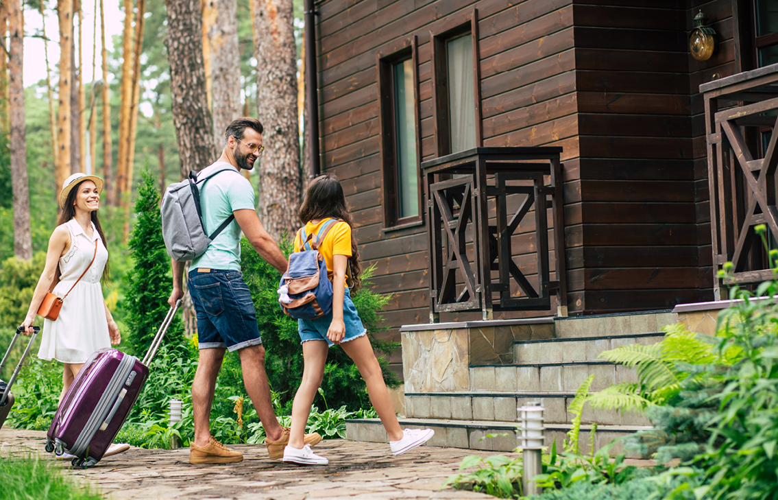 Family of Three Walking into Lodge